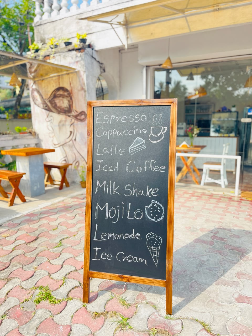 Hand-drawn chalkboard menu outside Cafe' Co.